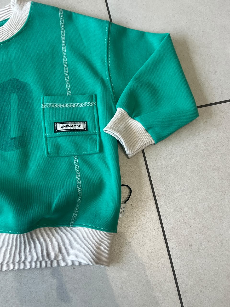 Kids Emerald Green Contrast Stitch Fleece Sweatshirt with Pocket | Ages 3–7, detail view, aataa kidd