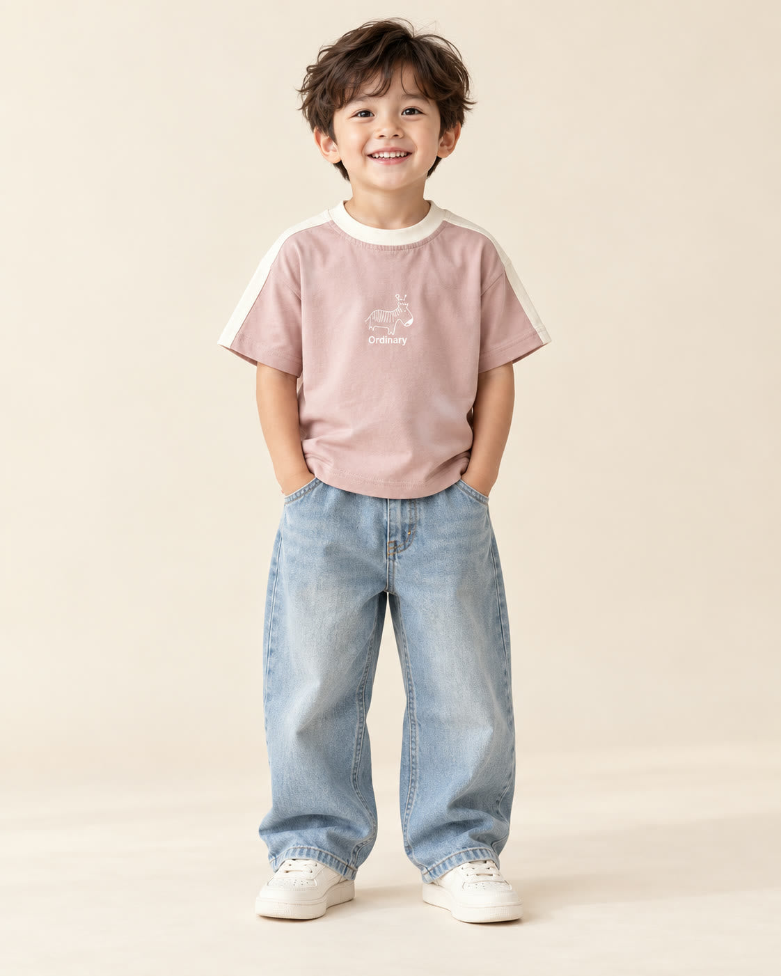 Boy wearing dusty pink zebra graphic T-shirt with loose light-wash jeans