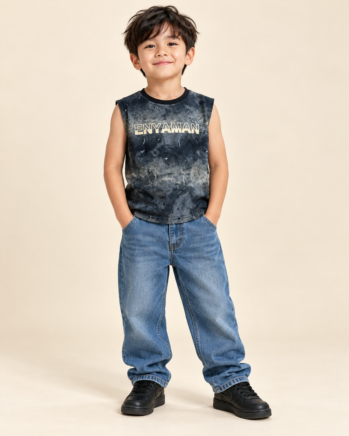 Boy wearing charcoal mineral-wash ENYAMAN sleeveless tank with loose jeans