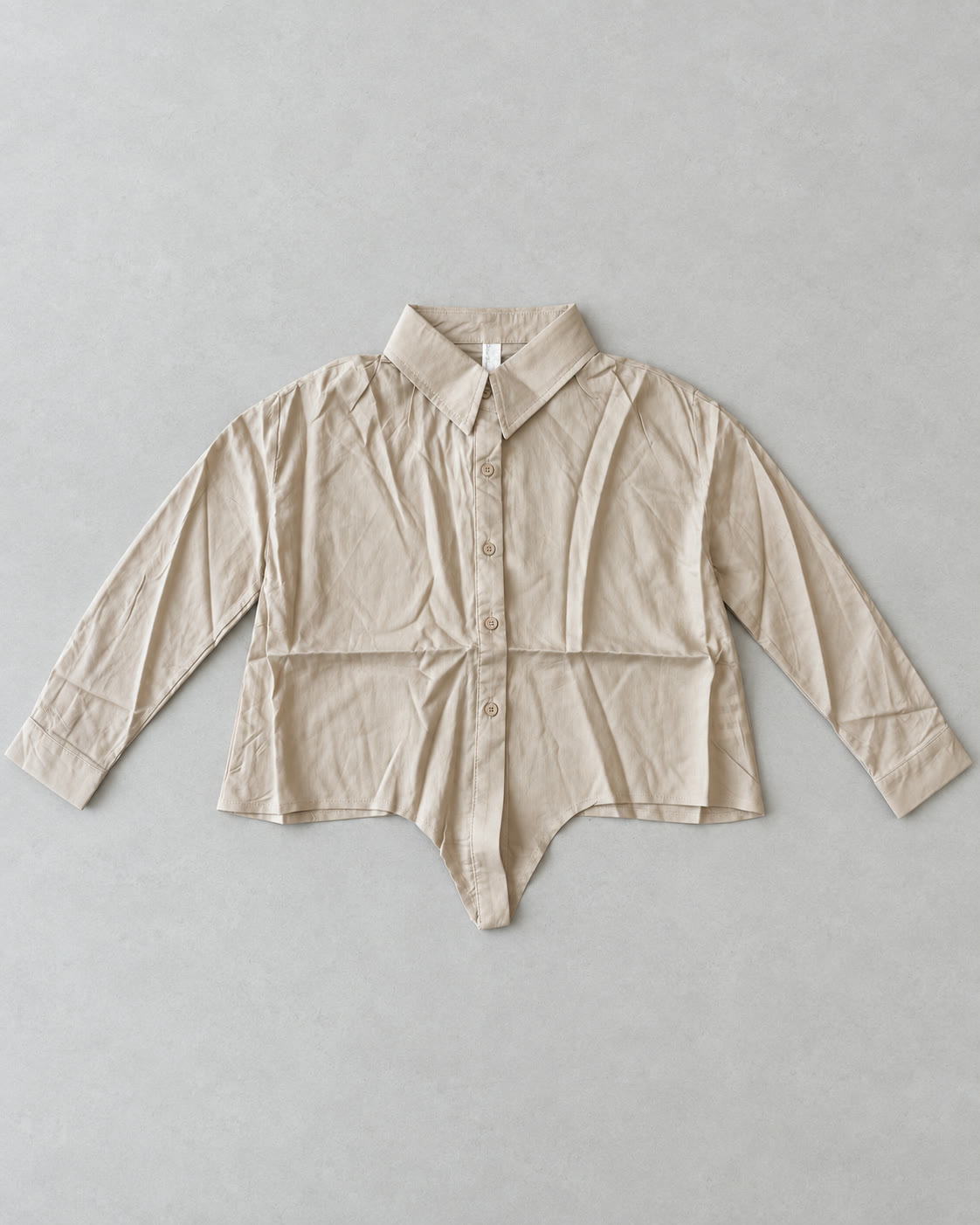 Beige long-sleeve pointed-tail button-down shirt flat lay, product only