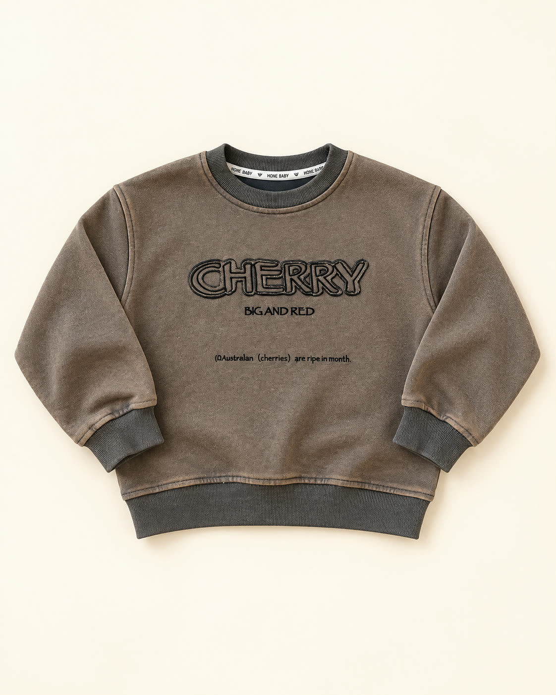 Flat lay of taupe CHERRY graphic sweatshirt