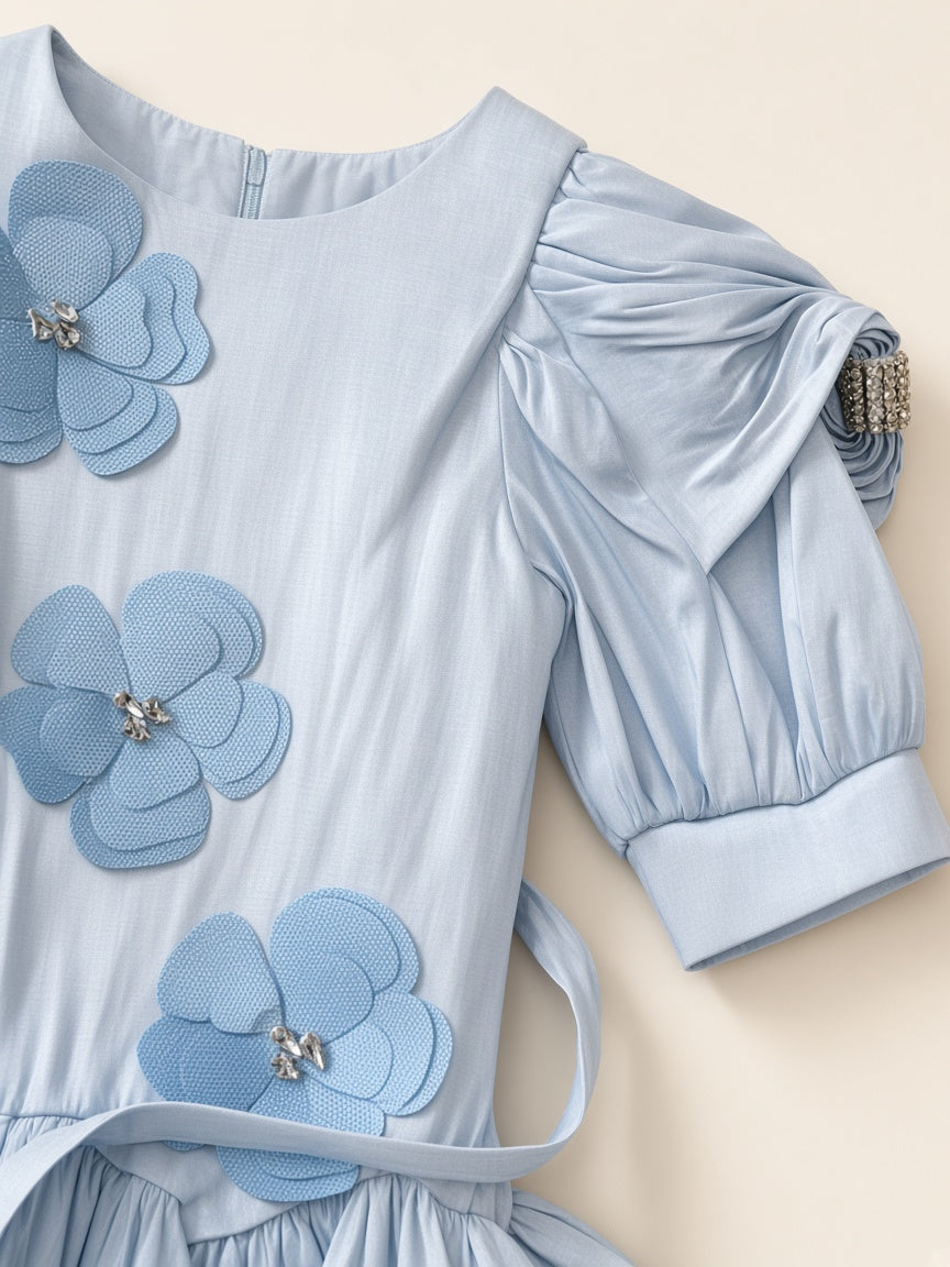 Close detail of icy blue frock rhinestone sleeve band and matching mesh floral appliques