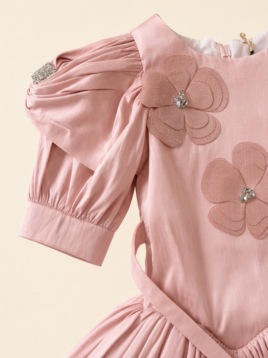 Close detail of dusty pink frock rhinestone sleeve band and matching mesh floral appliques