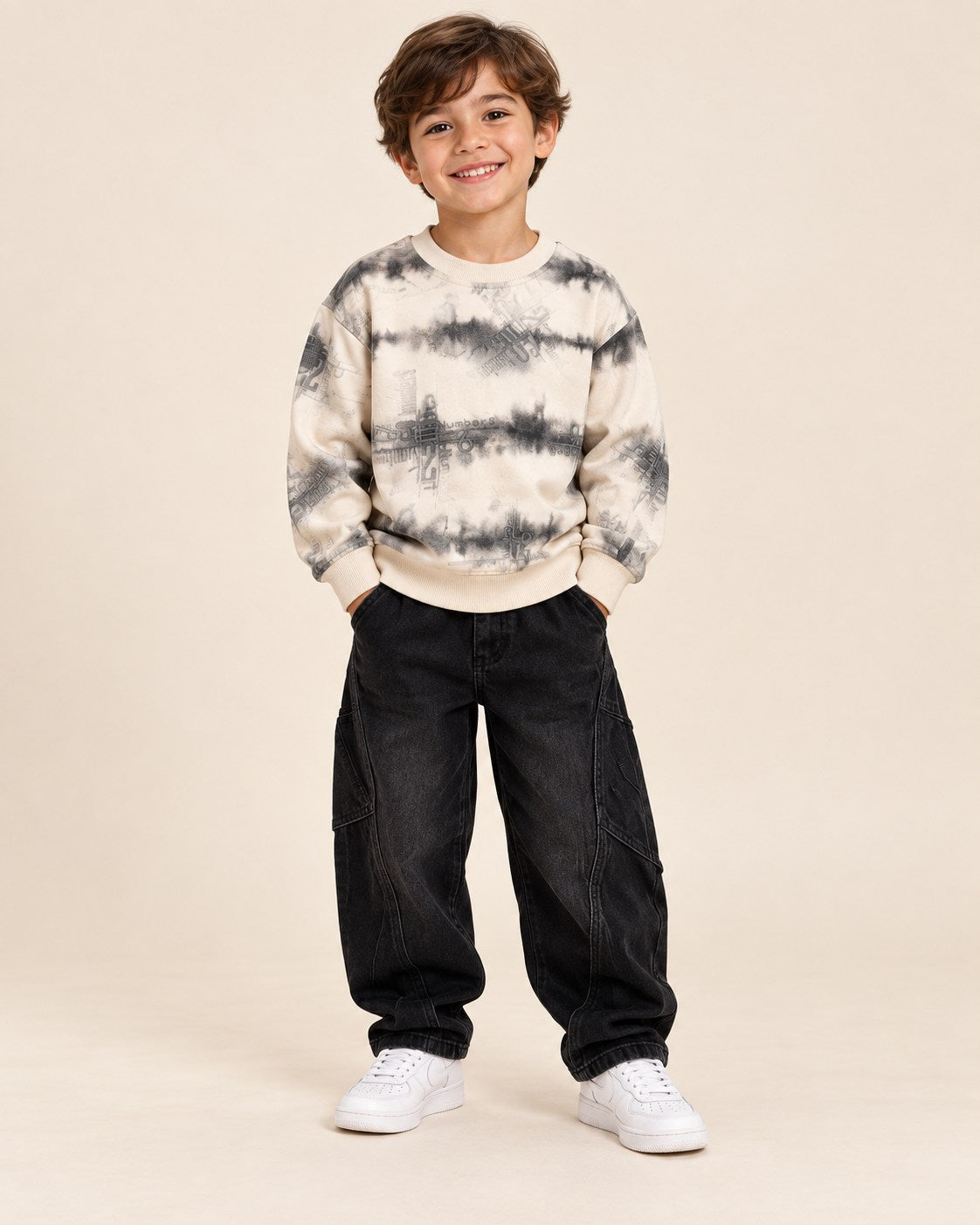 Boy wearing cream smoky tie dye graphic sweatshirt with black cargo pants
