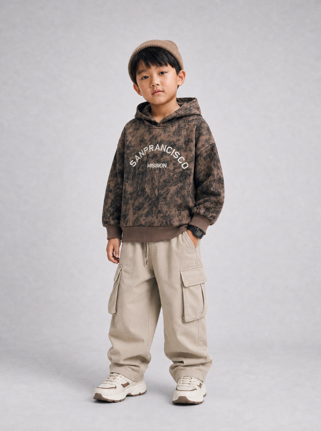 Boy wearing brown tie-dye hoodie with beige baggy cargo pants