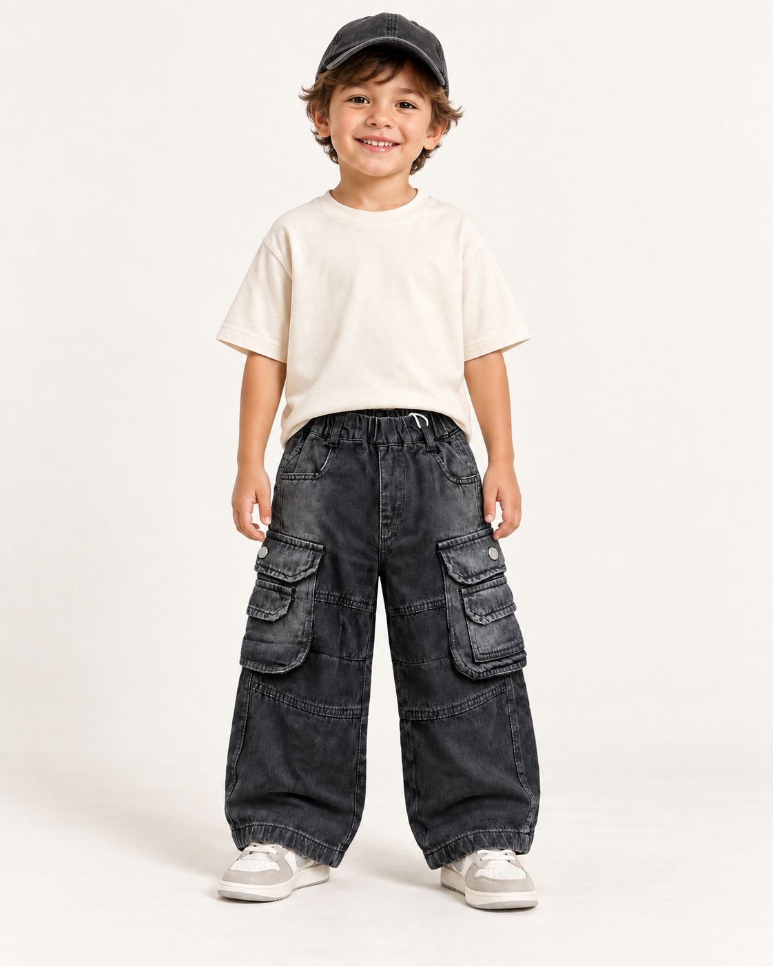 Boy wearing charcoal washed baggy cargo pants with layered utility pockets